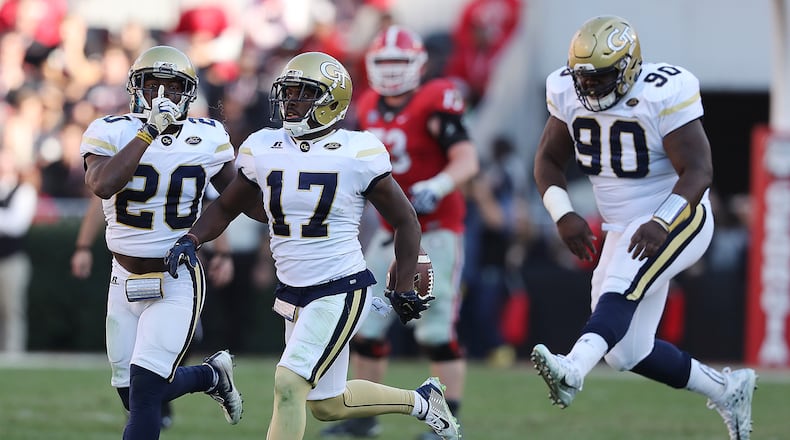 Georgia Tech defensive back Lance Austin (center) intercepts Georgia quarterback Jacob Eason during the fourth quarter setting up the game-winning drive for a 28-27 victory against Georgia on Saturday, Nov. 26, 2016, in Athens. Tech defenders Lawrence Austin (left) and Brandon Adams celebrate on the play. Curtis Compton/ccompton@ajc.com