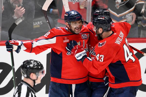 Washington Capitals left wing Alex Ovechkin (8) celebrates his goal with right wing Tom Wilson during the third period of an NHL hockey game against the Calgary Flames, Tuesday, Feb. 25, 2025, in Washington. (AP Photo/Nick Wass)