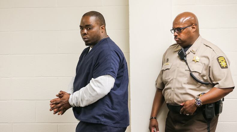Cameron Tucker is led into court for his first court appearance Wednesday morning. Charges against him were upgraded, delaying the court hearing by two hours. (Photo: John Spink/jspink@ajc.com)