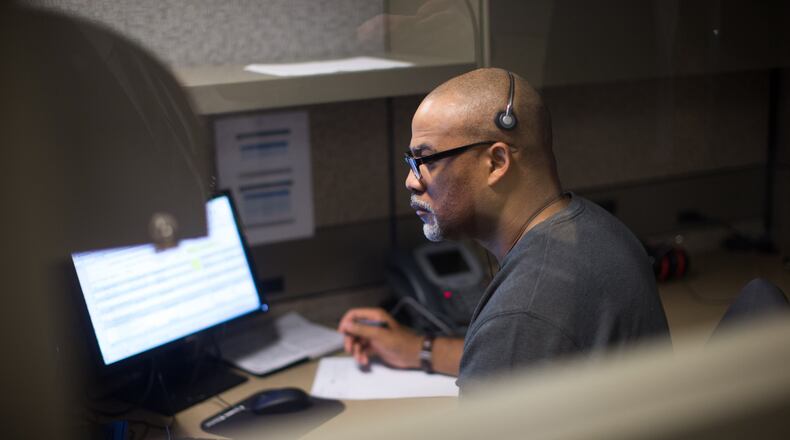 Responder Howard Hill, who is a former Marine, listens to a caller at the VA’s crisis hotline call center in Atlanta, Tuesday, Dec. 13, 2016. BRANDEN CAMP / SPECIAL