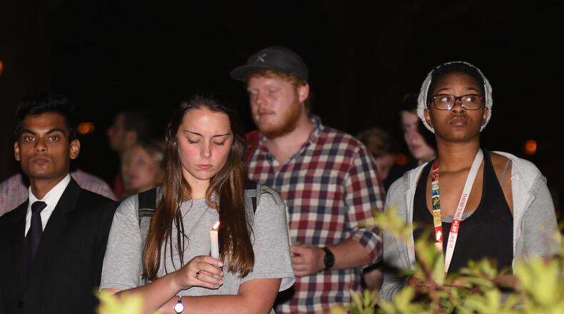 Friends embrace during the vigil in memory of Georgia Tech student Scout Schultz, one of 30 Georgians shot and killed by police in 2017. Schultz was suicidal. Roughly a quarter of 2017 shootings involved mental illness. REBECCA BREYER