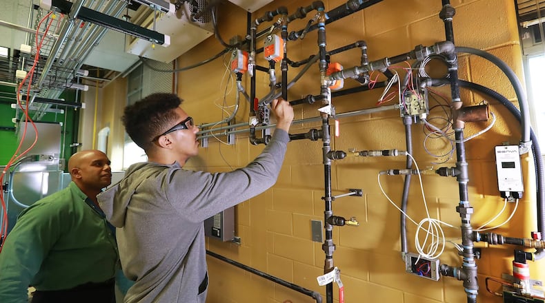 Building automation instructor Robert Croom looks on while student Jomaris Soseph works on a hydronic wall during his class in the Building Automation Systems program at Georgia Piedmont Technical College on Thursday, Jan. 30, 2020, in Clarkston. CURTIS COMPTON / CCOMPTON@AJC.COM