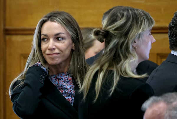 Defendant Karen Read smiles at her family before closing arguments during her murder trial in Norfolk Superior Court, Friday, June 13, 2025, in Dedham, Mass. (Mark Stockwell/The Sun Chronicle via AP, Pool) /// [EXTERNAL]