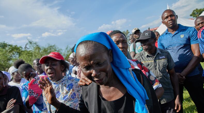 Professional mourners grieve alongside family members and friends of the deceased during a funeral on the outskirts of Kisumu, Kenya, Friday, March 13, 2026. (AP Photo/Asa Wallin)