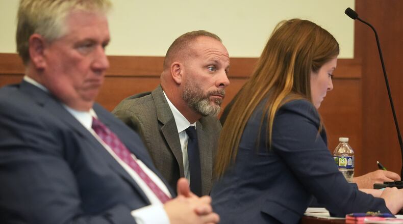 FILE - Jason Meade, center, sits with his attorneys Mark Collins, left, and Kaitlyn Stephens, right, during opening statements in the retrial of the former Ohio sheriff's deputy charged with murder and reckless homicide in the 2020 killing of Casey Goodson Jr., inside Franklin County Common Pleas Court in Columbus, Ohio, April 23, 2026. (Doral Chenoweth/Pool photo via AP, File)