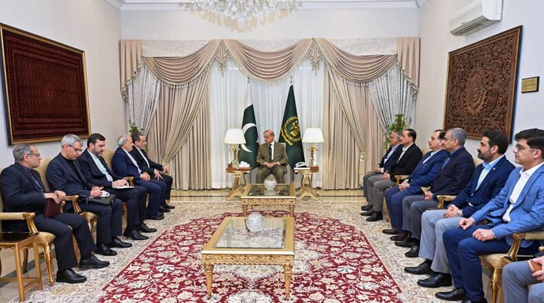 In this photo released by the Pakistan Prime Minister Office, Iran's Foreign Minister Abbas Araghchi, fifth left, meets with Prime Minister Shehbaz Sharif, center, in Islamabad, Pakistan, Saturday, April 25, 2026. (Pakistan Prime Minister Office via AP)