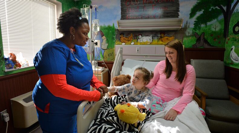 December 18, 2014 Eastman - Shareem Wrease (left), RN, checks her patient McKayla Dupree, 6, as her mother Ashley Rowland (right) comforts McKayla at Dodge County Hospital in Eastman on Thursday, December 18, 2014. Nestled amid the small town of Eastman 140-some-odd miles south of downtown Atlanta, the Dodge hospital once stood on the brink of financial collapse. A new CEO was able to save it by slashing jobs and budgets. But the hospital still needed tens of thousands of dollars from the county government to keep the doors open and will eventually be forced to ask for even more taxpayer money if it is to survive long-term. HYOSUB SHIN / HSHIN@AJC.COM Eastman - Shareem Wrease (left), RN, checks her patient McKayla Dupree, 6, as her mother Ashley Rowland (right) comforts McKayla at Dodge County Hospital in Eastman last year. Nestled amid the small town of Eastman 140-some-odd miles south of downtown Atlanta, the Dodge hospital once stood on the brink of financial collapse. A new CEO was able to save it by slashing jobs and budgets. But the hospital still needed tens of thousands of dollars from the county government to keep the doors open and will eventually be forced to ask for even more taxpayer money if it is to survive long-term. Hyosub Shin, hshin@ajc.com