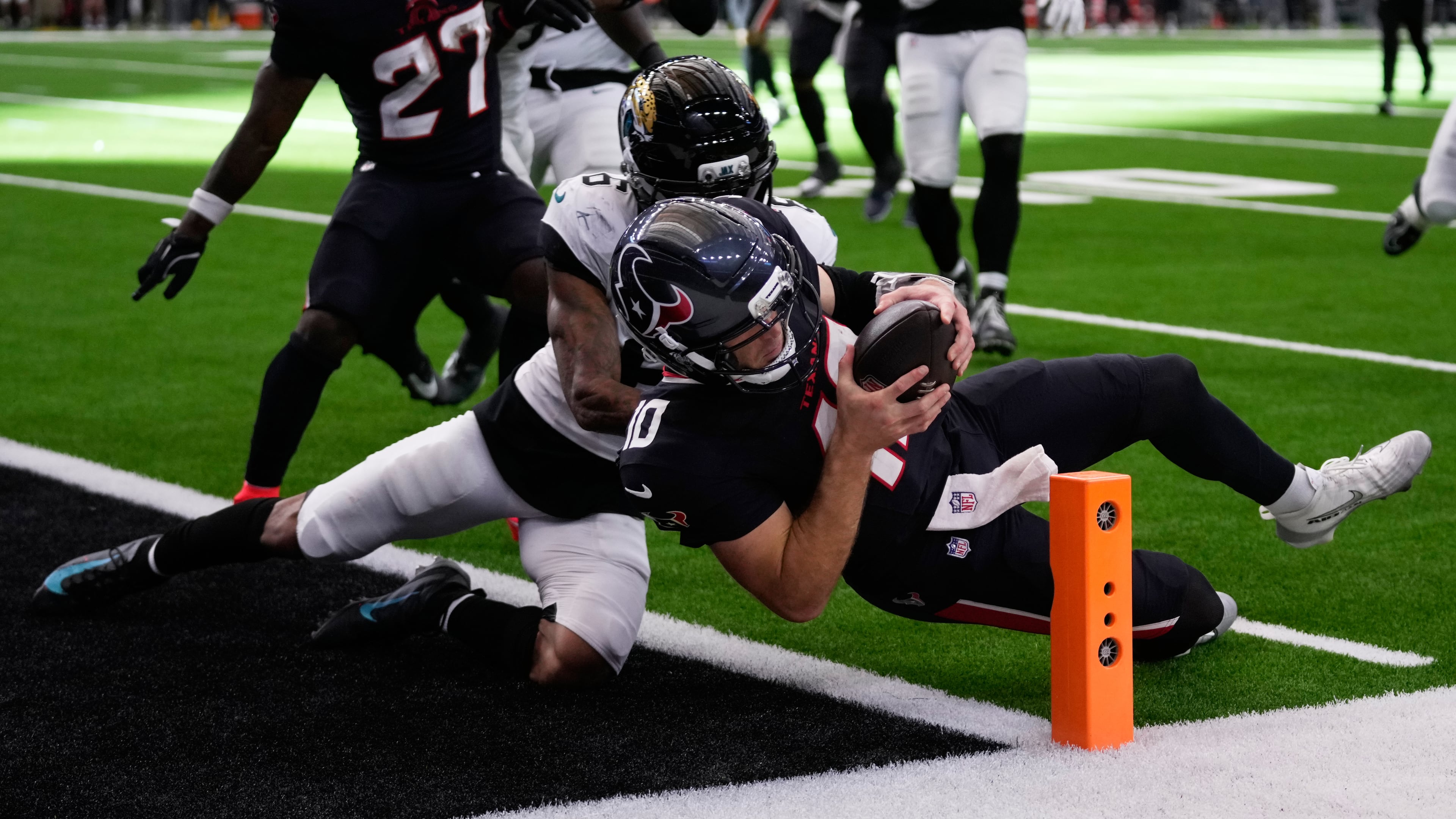 Houston Texans quarterback Davis Mills (10) scores a touchdown against Jacksonville Jaguars cornerback Greg Newsome II (6) during the second half of an NFL football game, Sunday, Nov. 9, 2025, in Houston. (AP Photo/Eric Christian Smith)