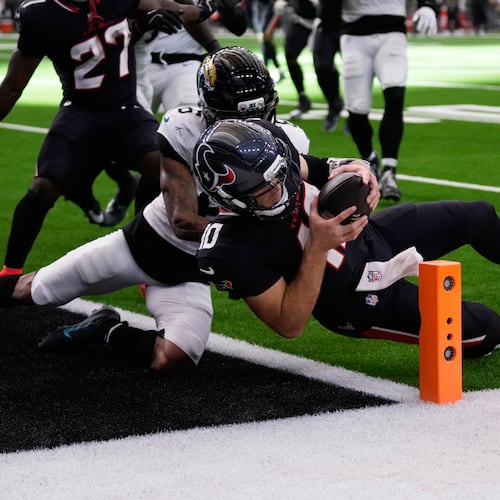 Houston Texans quarterback Davis Mills (10) scores a touchdown against Jacksonville Jaguars cornerback Greg Newsome II (6) during the second half of an NFL football game, Sunday, Nov. 9, 2025, in Houston. (AP Photo/Eric Christian Smith)