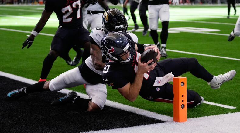 Houston Texans quarterback Davis Mills (right) scores a touchdown against Jacksonville Jaguars cornerback Greg Newsome II on Sunday, Nov. 9, 2025, in Houston. (Eric Christian Smith/AP)