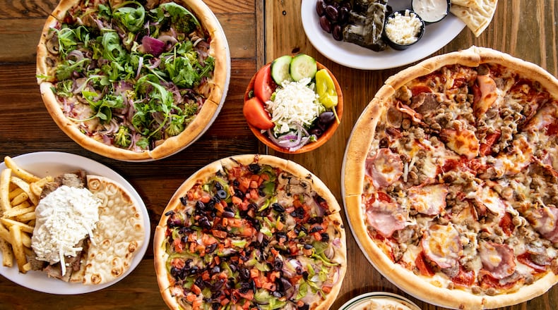 The Greek Pizzeria and Gyros will offer food such as Vegan Pizza (upper left), Gyro Platter (lower left), Supreme Vegetarian Specialty Pie (lower center), Meat Lovers Specialty Pie (right), Sampler Platter (upper right), and sides of pita (lower right) and a Greek salad (upper center). (Mia Yakel for The Atlanta Journal-Constitution)