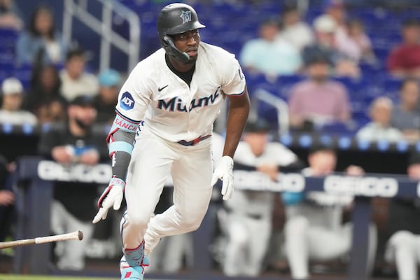 Miami Marlins' Jesus Sanchez drops his bat after hitting a RBI single to score Nick Fortes during the third inning of a baseball game against the Colorado Rockies, Tuesday, June 3, 2025, in Miami. (AP Photo/Lynne Sladky)