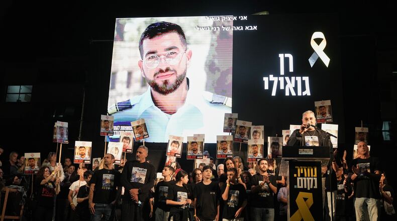 FILE - A photo of slain hostage Ran Gvili, whose remains are being held by Hamas in the Gaza Strip, is displayed during a rally calling for the return of the deceased hostages held in Gaza, in Tel Aviv, Israel, on Nov. 29, 2025. (AP Photo/Mahmoud Illean, File)