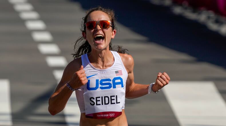 Molly Seidel, of the United States, celebrates as she crosses the finish line to win the bronze medal in the women's marathon at the 2020 Summer Olympics, Saturday, Aug. 7, 2021, in Sapporo, Japan (AP Photo/Shuji Kajiyama)