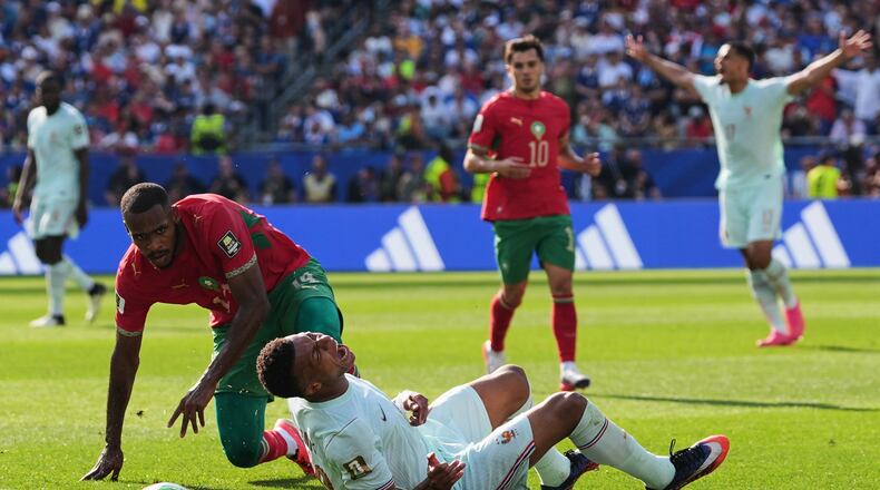 France's Kylian Mbappe (10) reacts to being tripped by Morocco's Issa Diop, left, during the World Cup quarterfinal soccer match between France and Morocco in Foxborough, Mass., near Boston, Thursday, July 9, 2026. (AP Photo/Stephanie Scarbrough)