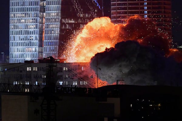 An explosion is seen during a missile attack in Tel Aviv, Israel, Friday, June 13, 2025. (AP Photo/Tomer Neuberg)