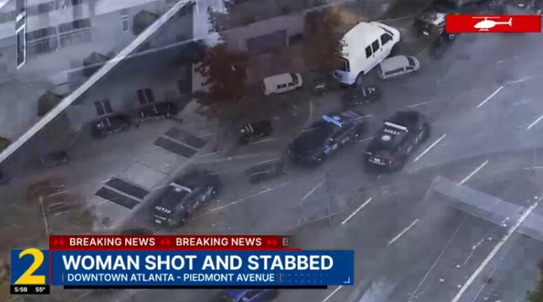 A man was found dead after falling from a downtown Atlanta apartment building, while a woman was found inside who had been both shot and stabbed, police said.