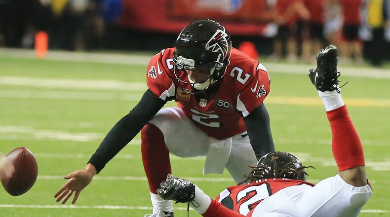 Falcons quarterback Matt Ryan fumbles the ball after a miscommunication with running back Devonta Freeman, one of four Falcons’ turnovers in a 23-20 overtime loss to Tampa Bay Sunday at the Georgia Dome. (Curtis Compton/ccompton@ajc.com)