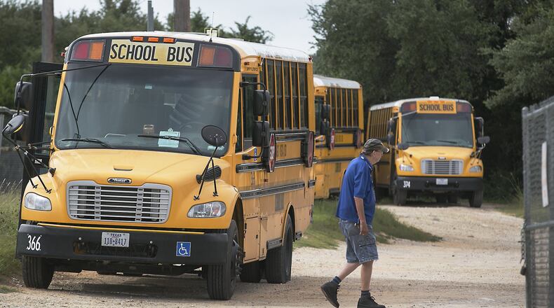 The Lago Vista school district’s bus barn is small in comparison to many other other districts’ as a worker walks through the area June 28. About 200 Texas school districts, four of them in Central Texas including Lago Vista, are slated to lose $200 million in state money come Sept. 1, from the Additional State Aid for Tax Reduction program, which was promised to school districts in 2006 to help them maintain the same revenue levels when the Legislature reduced property tax rates by a third.