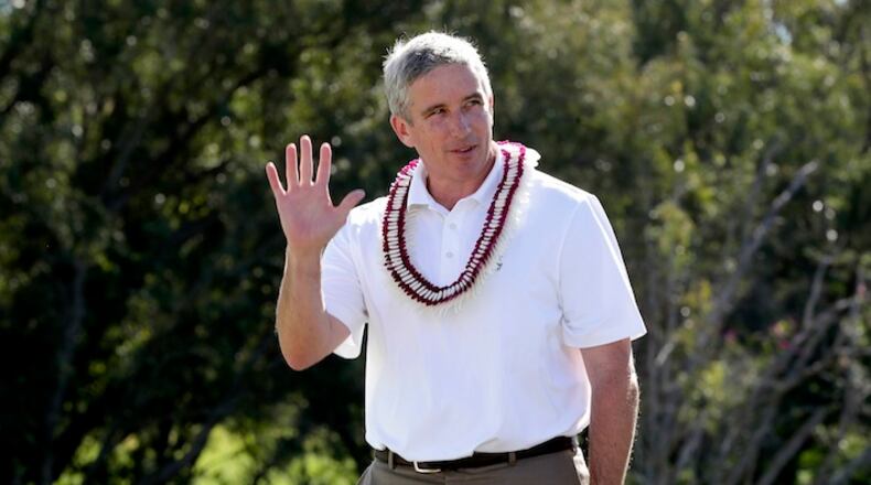 In this Jan. 8, 2017, file photo, PGA Commissioner Jay Monahan waves to fans before speaking after the final round of the Tournament of Champions golf event, at Kapalua Plantation Course in Kapalua, Hawaii. In his first year as PGA Tour commissioner, Jay Monahan said his top priority was to make Arnold Palmer proud. He has seen enough evidence halfway through the year to believe the tour is on the right track. (AP Photo/Matt York, File)