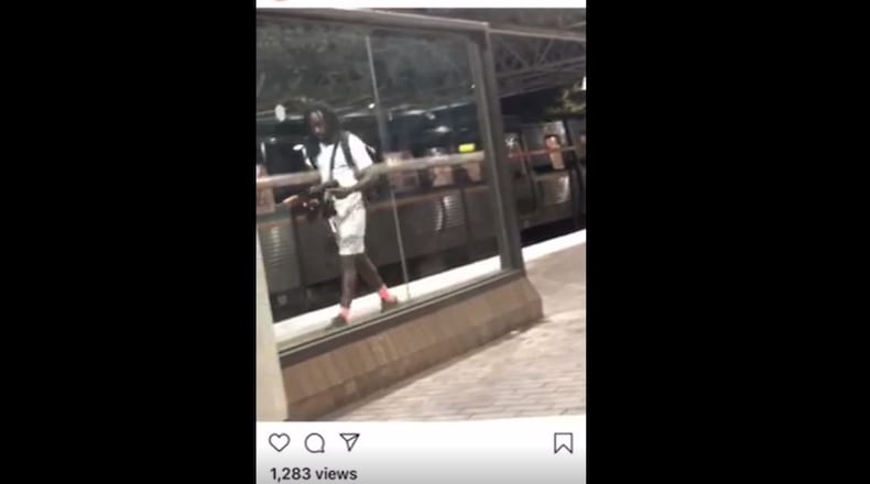 A video posted on social media shows a man holding what appeared to be an assault-style weapon and shouting at someone off-screen.