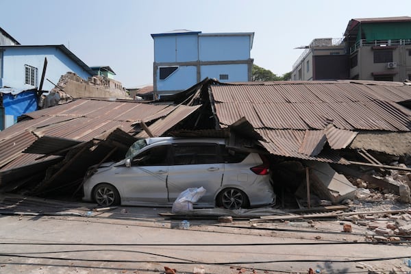 A car covered by a collapsed building due to the earthquake in Naypyitaw, Myanmar, Sunday, March 30, 2025. (AP Photo/Aung Shine Oo)