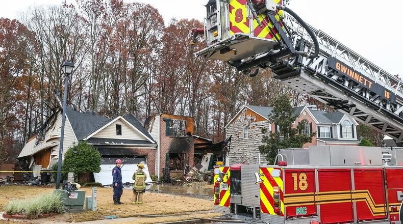 A man’s body was found behind this house in Buford. JOHN SPINK / JSPINK@AJC.COM
