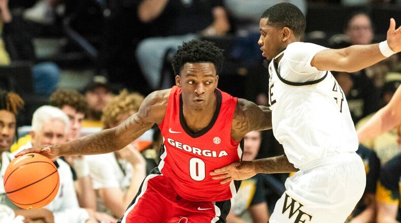 Georgia guard Terry Roberts (0) moves around the defense of Wake Forest guard Daivien Williamson (4) in the first half of an NCAA college basketball game Friday, Nov. 11, 2022, in Winston-Salem, N.C. (Allison Lee Isley/The Winston-Salem Journal via AP)