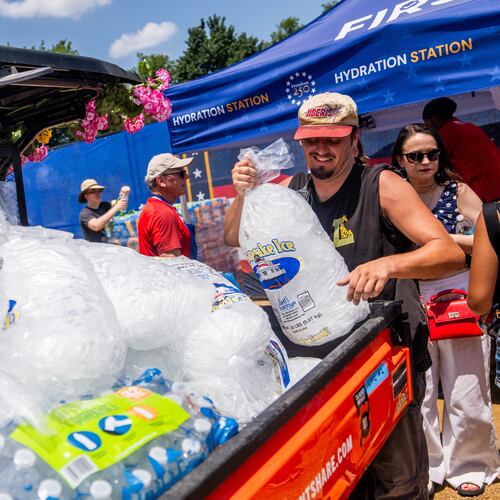 Vendors distribute ice at the Great American State Fair on the National Mall, Friday, July 3, 2026, in Washington. (AP Photo/Allison Robbert)