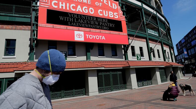 In this April 16, 2020 file photo, Wrigley Field's marquee displays Lakeview Pantry volunteer information in Chicago.