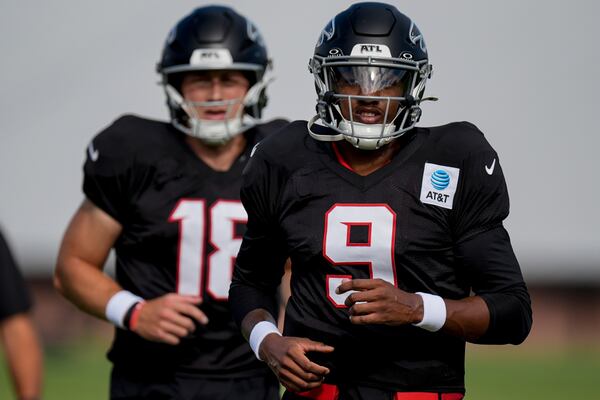 Falcons quarterback Michael Penix Jr. (right) works out fellow QB Jack Strand in Flowery Branch. (Mike Stewart/AP)