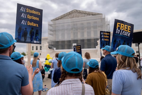 Supporters of charter schools rally outside of the Supreme Court on Wednesday, April 30, 2025, in Washington. (AP Photo/Mark Schiefelbein)