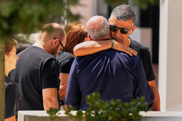 Joaquim, center, father of Liverpool forward Diogo Jota and his brother, is embraced at a church where their bodies have been brought for a wake and funeral, in Gondomar, near Porto, Portugal, on Friday, July 4, 2025. (AP Photo/Manu Fernandez)