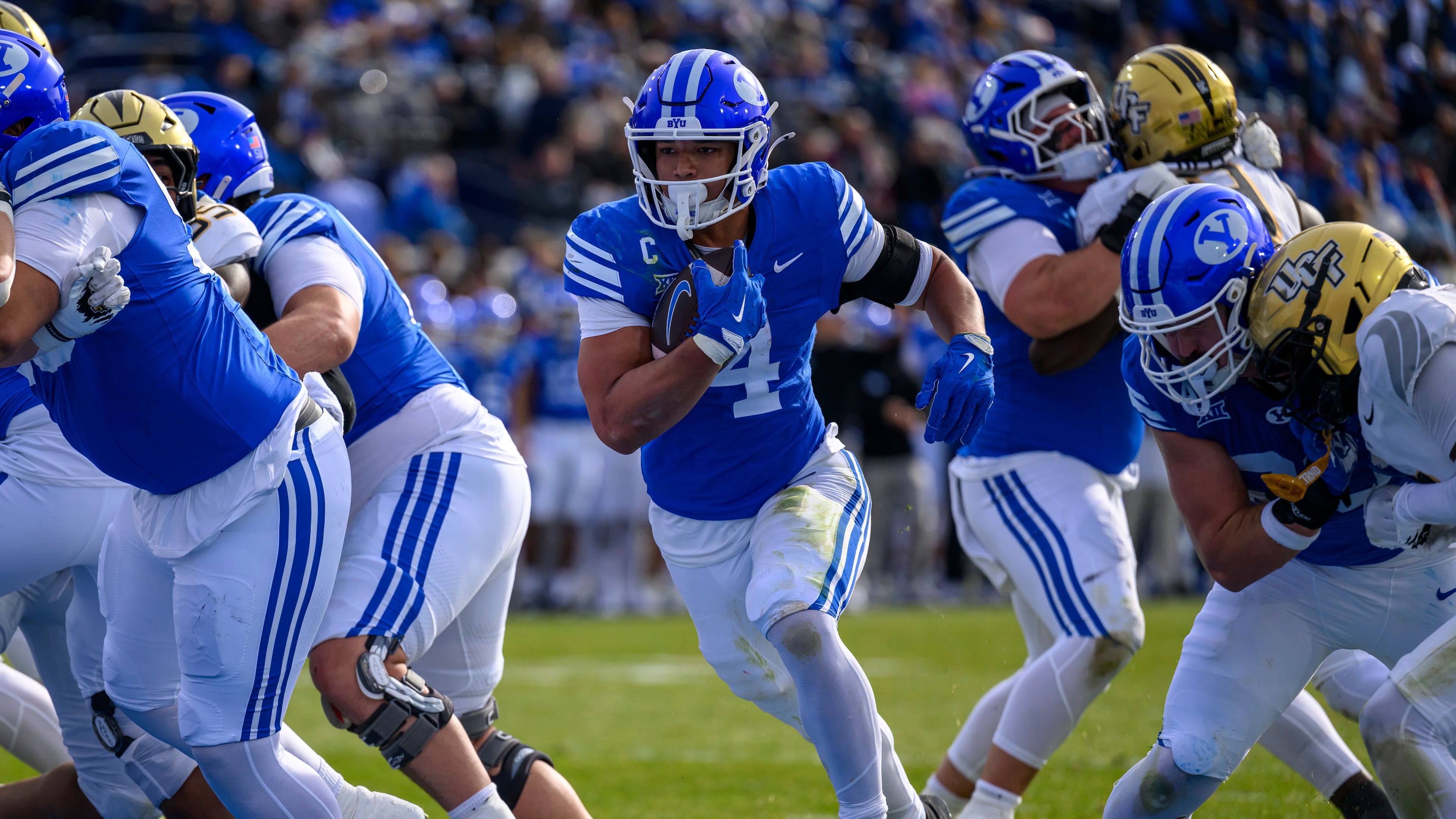 BYU running back LJ Martin (4) runs the ball in for a touchdown during the first half an NCAA college football game, Saturday, Nov. 29, 2025, in Provo, Utah. (AP Photo/Tyler Tate)