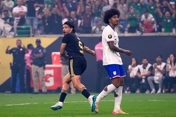 Mexico forward Raúl Jiménez (9) celebrates after scoring as he sprints past United States defender Chris Richards (3) in the first half of the CONCACAF Gold Cup final soccer match in Houston, Sunday, July 6, 2025. (AP Photo/David J. Phillip)
