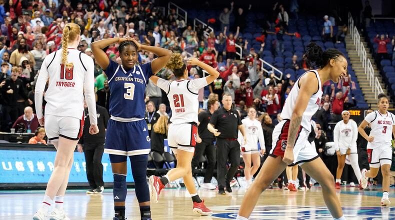 Georgia Tech guard Dani Carnegie (3) stands dejected as North Carolina State players celebrate an NCAA college basketball game in the quarterfinals of the Atlantic Coast Conference tournament Greensboro, N.C., Friday, March 7, 2025. (AP Photo/Chuck Burton)