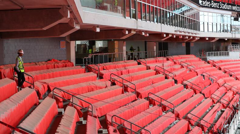 Newly installed seats are covered to prevent possible damage as construction continued on Mercedes-Benz Stadium on Thursday. (Curtis Compton/ccompton@ajc.com)
