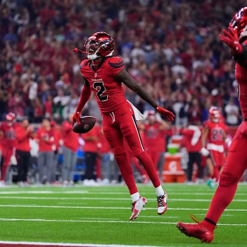 Houston Texans safety Calen Bullock (2) celebrates after intercepting a Buffalo Bills' Josh Allen pass in the second half of an NFL football game Thursday, Nov. 20, 2025, in Houston. (AP Photo/Ashley Landis)
