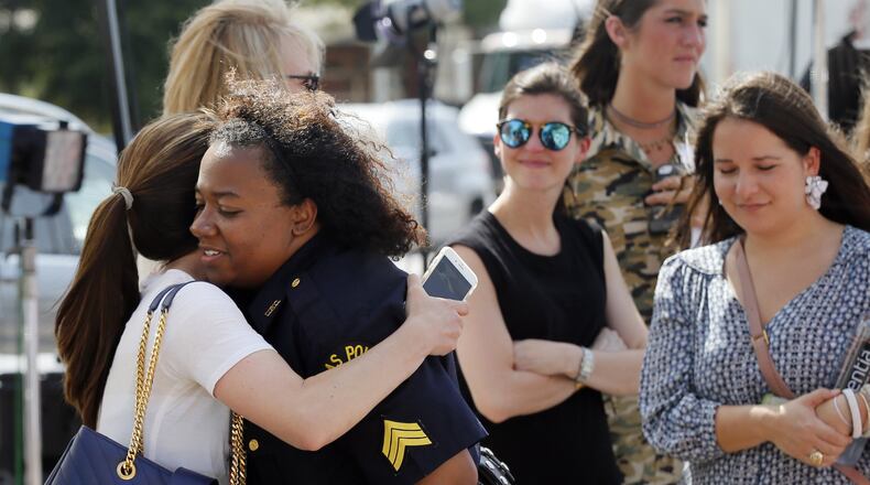 A well-wisher hugs Dallas police Sgt. Jamie Matthews (right) as they both visit a makeshift memorial in front of the department’s headquarters on July 11, 2016, in Dallas. Five police officers were killed and several were wounded in last week’s ambush. AP PHOTO / TONY GUTIERREZ