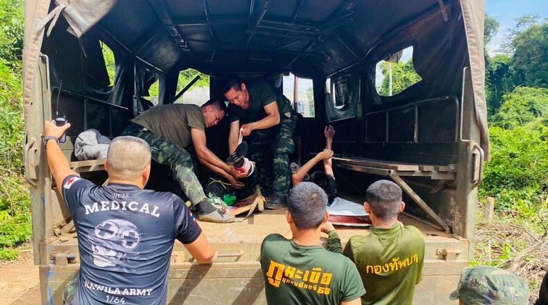 In this photo released by Royal Thai Army, two Thai soldiers injured by a landmine during a patrol near the Thai-Cambodia border are treated as they are to be transferred to a hospital in Sisaket province, Thailand, Monday, Nov. 10, 2025. (Royal Thai Army via AP)