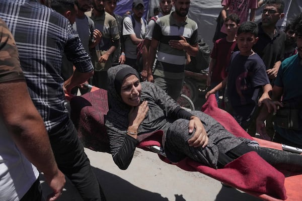 A woman is evacuated after an Israeli strike on tents sheltering displaced Palestinians in Gaza City on Tuesday, July 8, 2025. (AP Photo/Jehad Alshrafi)