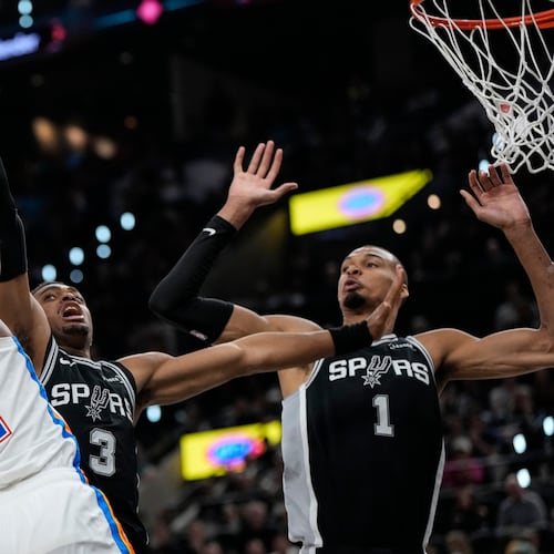 Oklahoma City Thunder guard Cason Wallace (22) shoots against San Antonio Spurs forward Keldon Johnson (3) in the second half of Game 6 in the Western Conference finals NBA basketball playoffs series, Thursday, May 28, 2026, in San Antonio. (AP Photo/David J. Phillip)