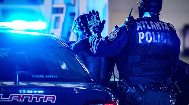 An Atlanta officer arrests a suspect during a weekend crackdown on street racing.