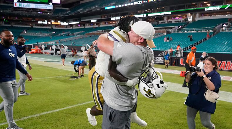 Georgia Tech head coach Brent Key picks up running back Jamal Haynes as they celebrate their 23-20 win over Miami in an NCAA college football game, Saturday, Oct. 7, 2023, in Miami Gardens, Fla. (AP Photo/Wilfredo Lee)