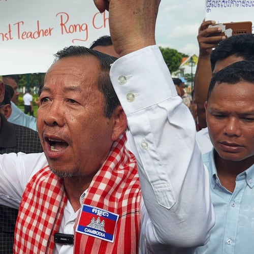 Rong Chhun, a top adviser to the Nation Power Party and a prominent opposition politician, stands with supporters outside Cambodia's Supreme Court in Phnom Penh, Friday, June 19, 2026. (AP Photo/Sopheng Cheang)