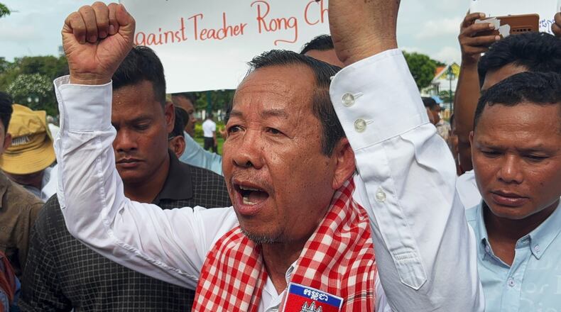 Rong Chhun, a top adviser to the Nation Power Party and a prominent opposition politician, stands with supporters outside Cambodia's Supreme Court in Phnom Penh, Friday, June 19, 2026. (AP Photo/Sopheng Cheang)