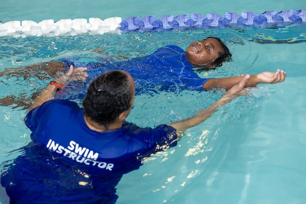 Lewis Davis, 4, participates in an adaptive swim lesson with instructor Lillian Thompson at the Decatur YMCA earlier this month. (Phil Skinner for the AJC)