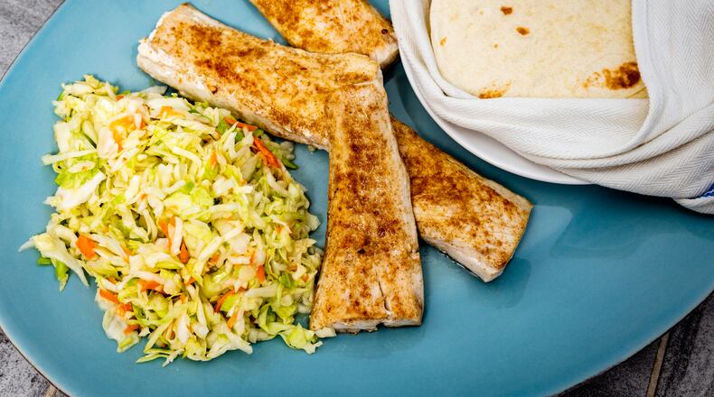 Fish Tacos with Shortcut Slaw can come together quickly for a weeknight meal. Henri Hollis/For The AJC