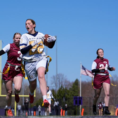 FILE - An Augustana University player, front, runs from a Concordia University, St. Paul player during a women's college flag football game, April 7, 2025, in St. Paul. Minn. (AP Photo/Abbie Parr, File)