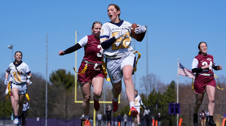 FILE - An Augustana University player, front, runs from a Concordia University, St. Paul player during a women's college flag football game, April 7, 2025, in St. Paul. Minn. (AP Photo/Abbie Parr, File)